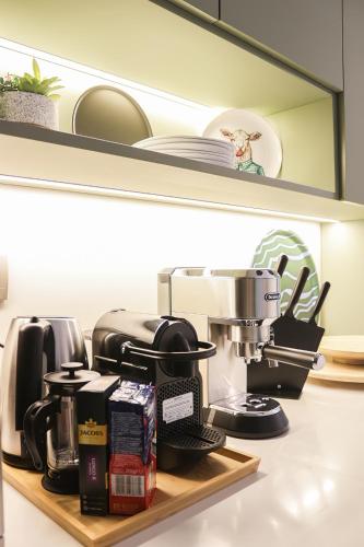 a kitchen counter with a coffee maker on a shelf at Nabeel Homes - Seaview Building - 3 Units in Gleem in Alexandria