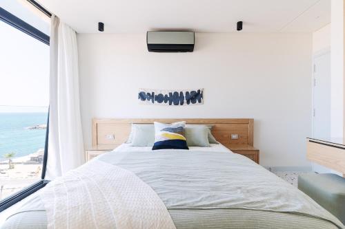 a bedroom with a bed with a view of the ocean at Nabeel Homes - Seaview Building - 3 Units in Gleem in Alexandria