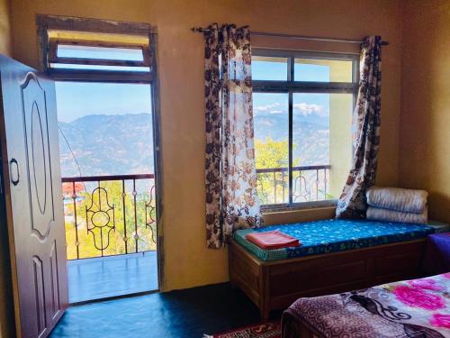 a bedroom with a bed and a window with a view at Aroma Homestay in Kalimpong