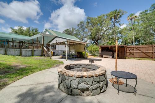 a patio with a fire pit and a table at Pool Access Homosassa Home Near Boat Launch! in Homosassa