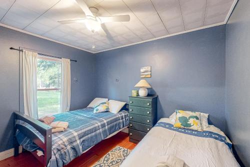a bedroom with two beds and a ceiling fan at Wanderlust in Glen Arbor