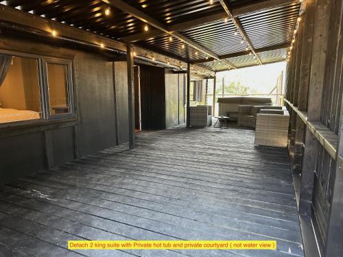 an empty porch of a building with chairs on it at TheWaterfrontLodges in Coventry