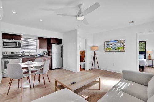 a living room with a table and a kitchen at Waves On Walnut - Beach Access in Hollywood