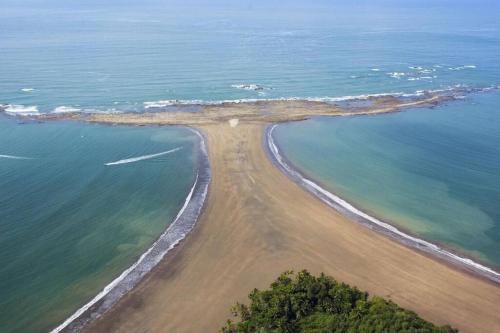 an aerial view of an island in the ocean at Sloth Premium Riverfront Jungle Villa with Jacuzzi and Pool in Uvita