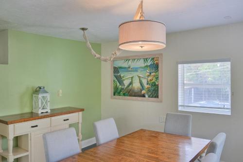 a dining room with a wooden table and chairs at Longboard in Holmes Beach