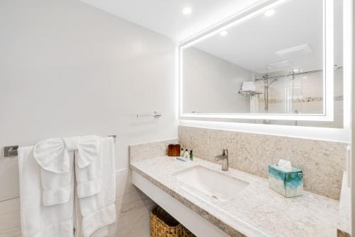 a bathroom with a sink and a mirror at Marina Views Studio - Ilikai, 941 in Honolulu