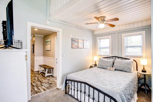 a bedroom with a bed and a ceiling fan at Pura Vida - 2 Houses - Murrells Inlet in Myrtle Beach