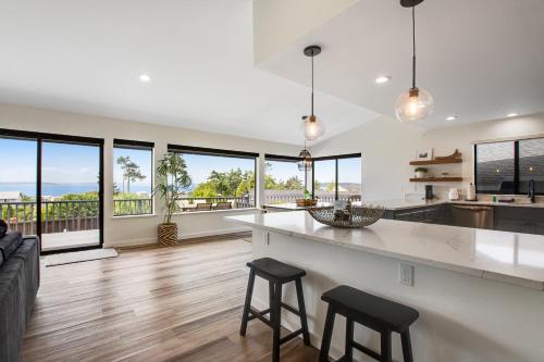a kitchen and living room with a counter and chairs at Admirals Cove in Coupeville