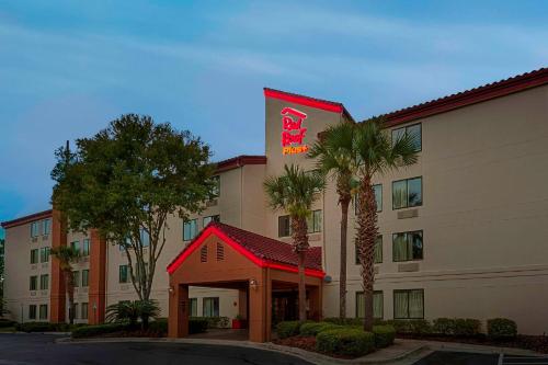 a hotel with a sign on the side of it at Red Roof Inn PLUS + Gainesville in Gainesville