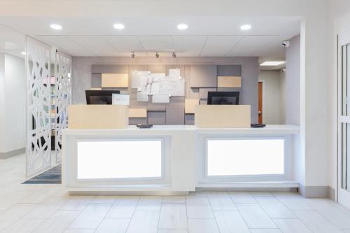an empty office with two blank billboards in a room at Holiday Inn Express & Suites Williamsburg by IHG in Williamsburg