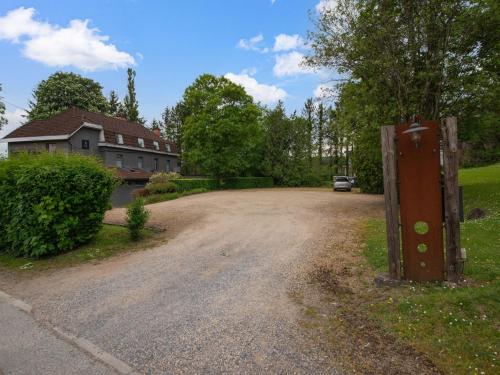 a dirt road in front of a house at Spacious Villa Near Barvaux in Barvaux