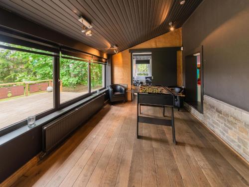 a room with a ping pong table in the middle at Spacious Villa Near Barvaux in Barvaux