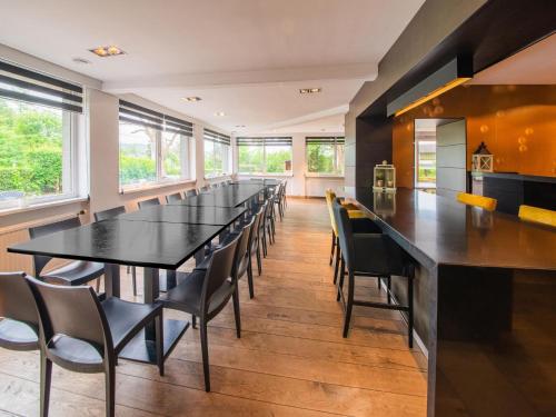 a large dining room with a long table and chairs at Spacious Villa Near Barvaux in Barvaux