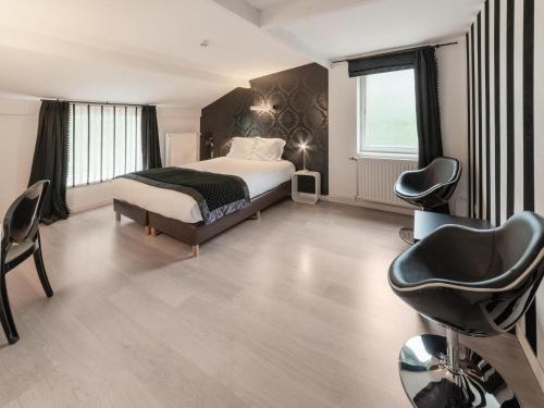 a bedroom with a bed and a desk and a chair at Spacious Villa Near Barvaux in Barvaux