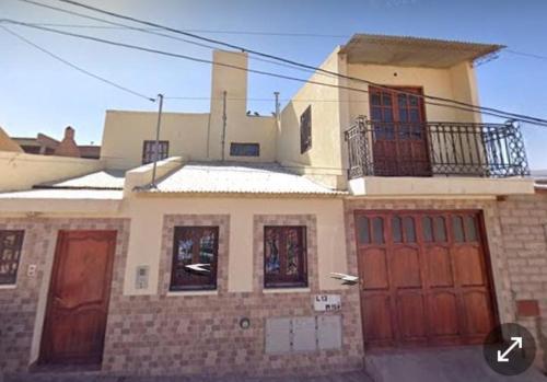 a large house with red doors and windows at CANGO in Humahuaca