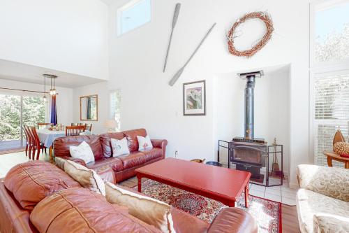 a living room with a couch and a wood stove at Castaway Cabin in Manzanita