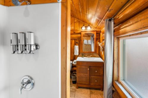 a bathroom with a sink and a mirror at The Bucking Moose in West Yellowstone