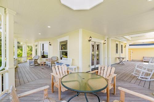 a porch with a glass table and chairs at Marty's Place in Langley