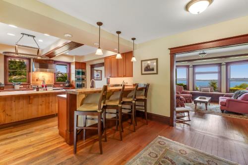 an open kitchen and living room with a bar and chairs at Marty's Place in Langley