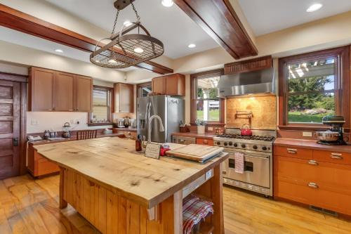 a kitchen with wooden cabinets and a large wooden island at Marty's Place in Langley