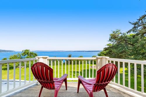 two chairs sitting on a porch with a view of the water at Marty's Place in Langley