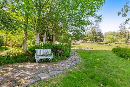 a park bench sitting on a stone path in a park at Marty's Place in Langley