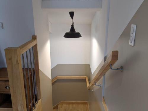 a stairway with a black light and a black lamp at Gîte Charentais avec piscine, terrasse, et pêche - confort moderne et charme rural - FR-1-653-87 in Salles-de-Barbezieux