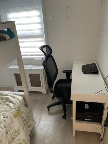 a bedroom with a desk and a chair and a bed at Renovated Jacuzzi Tub Home NYC-LGA-JFK Washer-Dryer in Kew Gardens