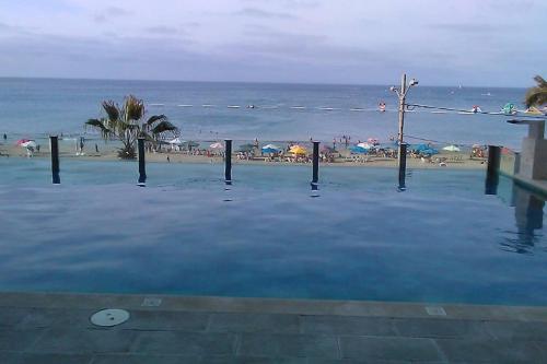 a large pool of water next to a beach at Dep. Salinas, Chipipe. in Salinas