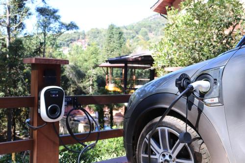 a car is hooked up to a car charger at Estalagem Serra de Minas em Monte Verde in Monte Verde