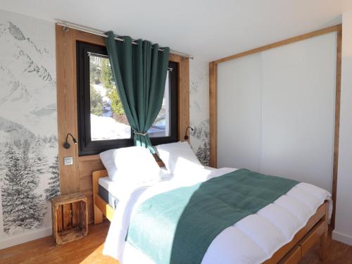 a bedroom with a bed and a window at Appartement Les Gets, 2 pièces, 4 personnes - FR-1-623-304 in Les Gets