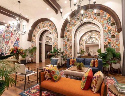 a lobby with a blue couch and a room with arches at A luxurious and romantic at Lacasita Huahin by Pikul in Hua Hin