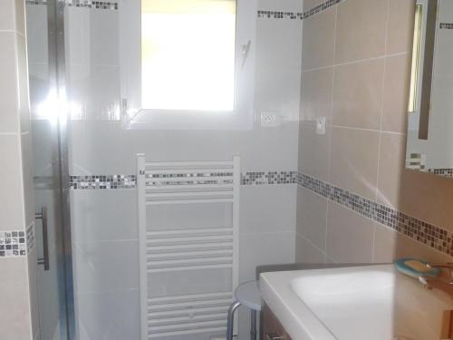 a white bathroom with a shower and a sink at Maison spacieuse 9 pers, secteur calme - FR-1-476-201 in La Faute-sur-Mer