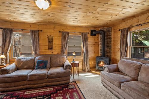 a living room with a couch and a fireplace at The Bucking Moose in West Yellowstone