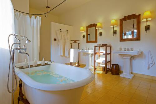 a large bathroom with a tub and two sinks at Ana Mandara Villas Dalat Resort & Spa in Da Lat