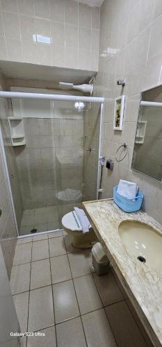 a bathroom with a shower and a sink and a toilet at Pousada Dona Felicidade Carneiros in Tamandaré