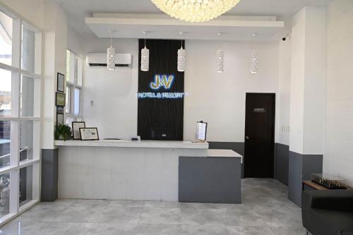 a lobby with a bar with a sign on the wall at J&V Hotel and Resort in Apaleng