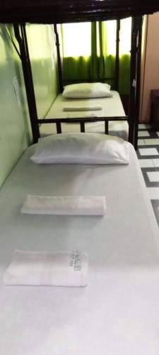 a bed with a price tag on it in a room at Bamboo Garden Bussiness Inn in Dipolog