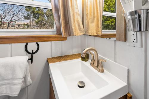 a bathroom with a sink and a window at The Bucking Moose in West Yellowstone