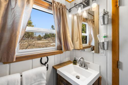 a bathroom with a sink and a window at The Bucking Moose in West Yellowstone