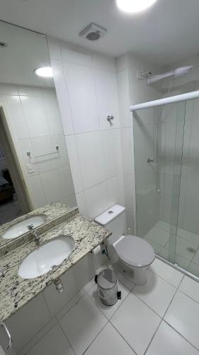 a bathroom with a sink and a toilet and a shower at Enseada - Vista Espetacular, Churrasqueira e Lazer in Guarujá