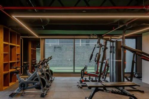 a gym with several cardio machines and a large window at Unique Design Loft w/ Terrace in Bogotá