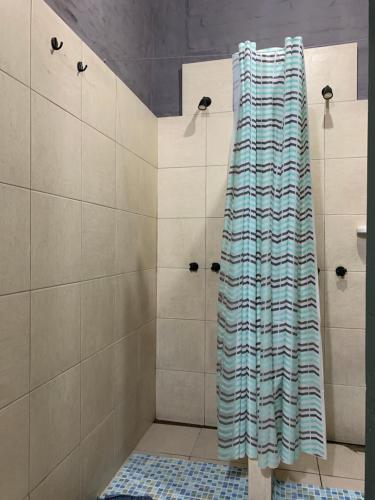 a shower with a striped shower curtain in a bathroom at MiBAQ Palermo in Buenos Aires
