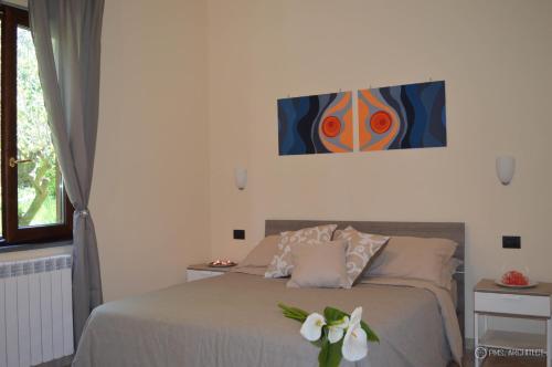a bedroom with a bed with white flowers on it at Il Rivolo in Sorrento