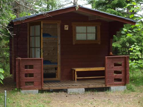 a log cabin with a porch and a deck at Värava Farm in Pidula