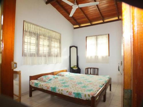 a bedroom with a bed in a room at Arogya Resort in Ambalangoda