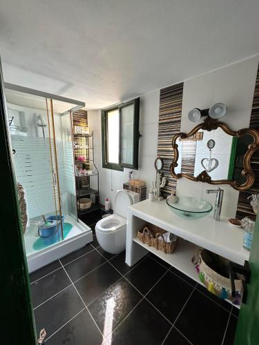 a bathroom with a toilet and a sink and a tub at Sunset in Megalochori