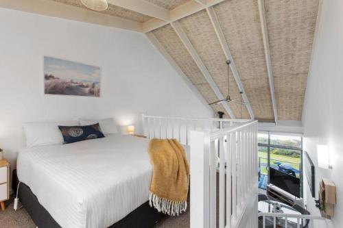 a bedroom with a white bed and a window at Ocean View Apartments at Whitecrest Great Ocean Road Resort in Apollo Bay