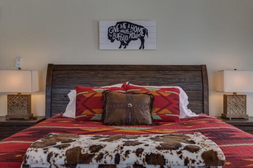 a bedroom with a bed with pillows and two lamps at Alpine Airspace by KABINO Airpark Foosball Garage Satellite in Alpine