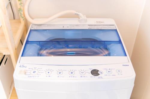 a washer and dryer sitting in a room at Yokkaichi Kawaramachi Hotel in Hazu
